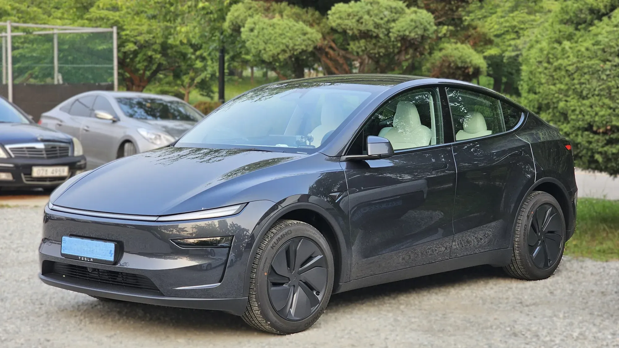 Tesla Model Y gris oscuro de la generación renovada, con la franja de luz que cruza el frente